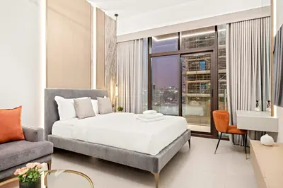 a bedroom with a bed and a couch at FIRST CLASS Studio Stylish Living in Dubai