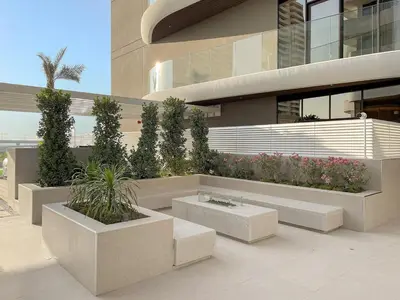 a building with a bench with plants in it at FIRST CLASS Studio Stylish Living in Dubai