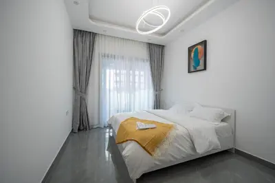 a white bedroom with a large bed and a window at Dubai Marina - 1 BHK Unique Apartment in Dubai