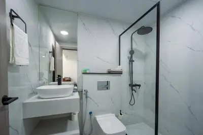 a bathroom with a shower and a sink and a toilet at Dubai Marina - 1 BHK Unique Apartment in Dubai