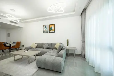 a living room with a couch and a table at Dubai Marina - 1 BHK Unique Apartment in Dubai