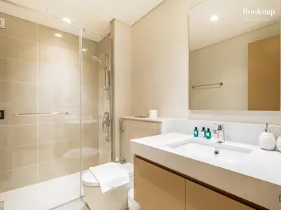 a bathroom with a sink and a shower and a toilet at Lavish 3BR Apartment with Assistant Room in Habour Gate Tower in Dubai