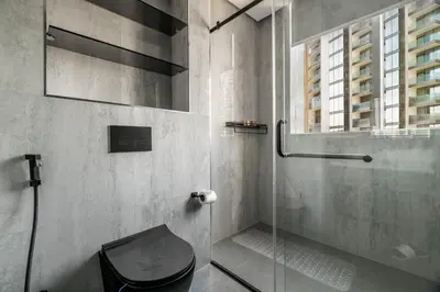a bathroom with a glass shower with a toilet at GuestReady - Mesmerizing Marina views at Iris Blue in Dubai