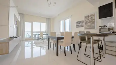 a kitchen and dining room with a table and chairs at April OFFER Huge 1BKH 4people & high floor in Dubai