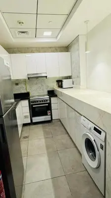 a kitchen with a washer and a washing machine at Elegant Guesthouse in Business Bay in Dubai