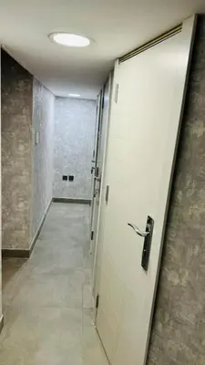 a hallway with a door leading to a room with a hallway at Elegant Guesthouse in Business Bay in Dubai