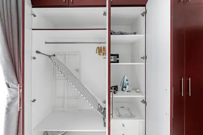 a bathroom with a glass shower door with a ladder at Time Place Near Metro and Mall in Dubai
