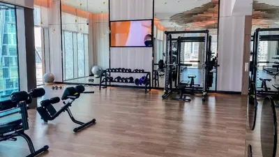 a gym with treadmills and machines in a room at Iconic 1Bedroom Duplex with Skyline Views Near Downtown Dubai & Burj Khalifa in Dubai