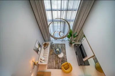 an overhead view of a living room with a large window at Iconic 1Bedroom Duplex with Skyline Views Near Downtown Dubai & Burj Khalifa in Dubai