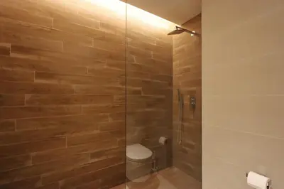 a bathroom with a glass shower with a toilet at Livbnb - Ain Dubai Panorama, 3BR with Maid's Room in Dubai