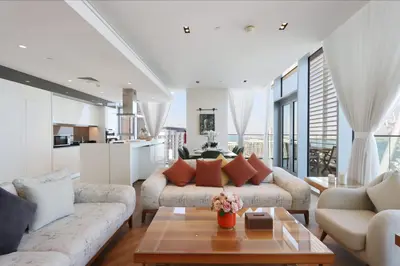 a living room with a couch and a table at Livbnb - Ain Dubai Panorama, 3BR with Maid's Room in Dubai