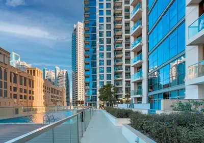 a walkway in a city with tall buildings at DreamShoma-1B Spacious Apartment in Dubai
