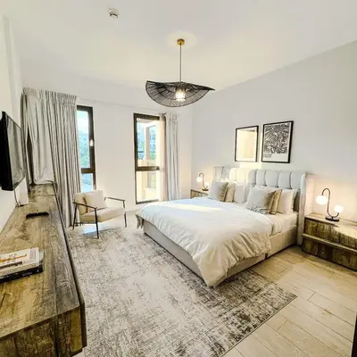 a white bedroom with a large bed and a couch at Lamtara 3 MJL in Dubai