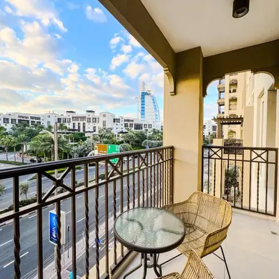 a balcony with a table and chairs and a view of a city at Lamtara 3 MJL in Dubai