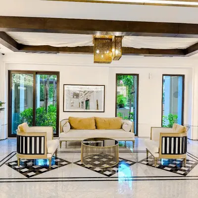 a living room with a couch and three chairs at Lamtara 3 MJL in Dubai