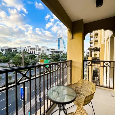 a balcony with a table and chairs and a view of a city at Lamtara 3 MJL in Dubai