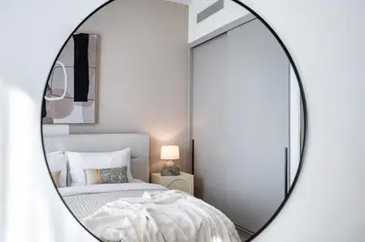 a mirror in a bedroom with a bed at The Smart Concierge - Signature Grande in Dubai