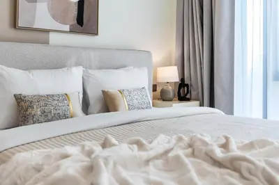 a bedroom with a white bed and a window at The Smart Concierge - Signature Grande in Dubai