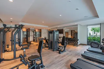 a gym with treadmills and elliptical machines at BLVD - Steps from Dubai mall and Dancing Fountain in Dubai