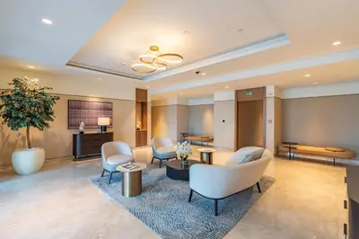 a lobby of a hotel with chairs and tables at BLVD - Steps from Dubai mall and Dancing Fountain in Dubai