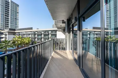 a balcony with a view of a building at Stylish 1BR APT with Gym, Pool & Private Parking in Dubai
