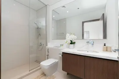 a bathroom with a toilet and a sink and a shower at Holiday Boulevard - Luxury 3BR Penthouse with Burj Khalifa and Creek Views in Dubai