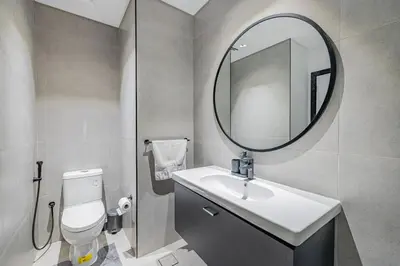 a bathroom with a sink and a mirror at Waves - Stunning 1BR with Huge Terrace & Scenic Views in Dubai
