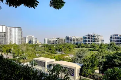a view of a city with tall buildings and trees at Apartment in Dubai Hills Park Acacia A in Dubai