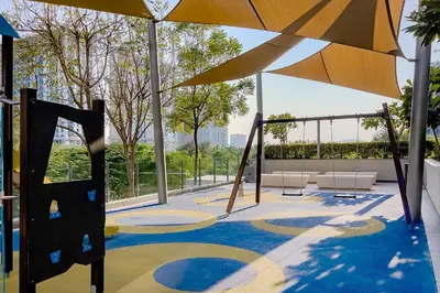 a playground with a slide and an umbrella at Apartment in Dubai Hills Park Acacia A in Dubai