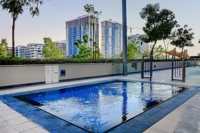 a swimming pool in a building with tall buildings at Apartment in Dubai Hills Park Acacia A in Dubai