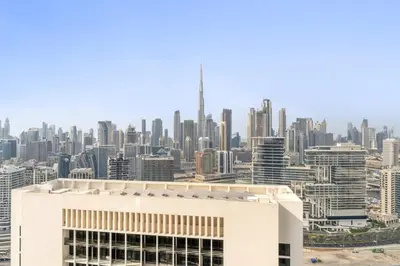 a view of a city skyline with a white building at Elegant 1BR with Panoramic Views on Burj Khalifa in Dubai