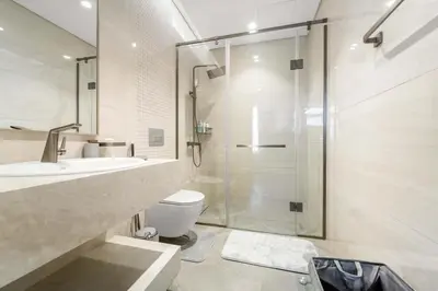 a bathroom with a shower and a toilet and a sink at Elegant 1BR with Panoramic Views on Burj Khalifa in Dubai