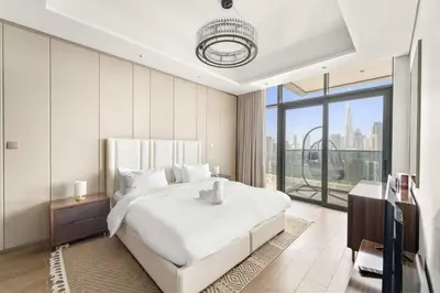 a bedroom with a white bed and a large window at Elegant 1BR with Panoramic Views on Burj Khalifa in Dubai