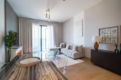 a living room with a glass table and a couch at Sea View l Port De LaMer l Next to Beach l Perfect for 4 in Dubai