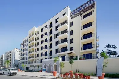 a large white apartment building on a city street at Sea View l Port De LaMer l Next to Beach l Perfect for 4 in Dubai