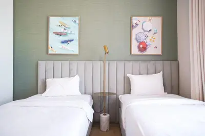 two beds sitting next to each other in a room at Sea View l Port De LaMer l Next to Beach l Perfect for 4 in Dubai