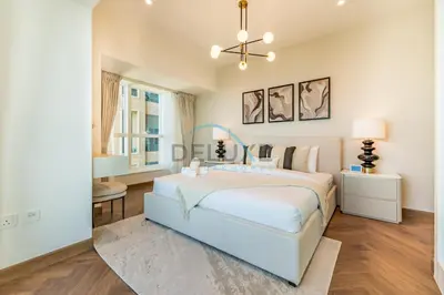 a white bedroom with a bed and a chandelier at Serene 2BR with Iconic Palm Jumeirah Views, Dubai Marina by Deluxe Holiday Homes in Dubai