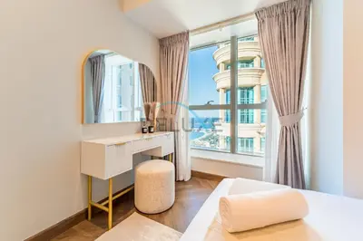 a bedroom with a desk and a large window at Serene 2BR with Iconic Palm Jumeirah Views, Dubai Marina by Deluxe Holiday Homes in Dubai