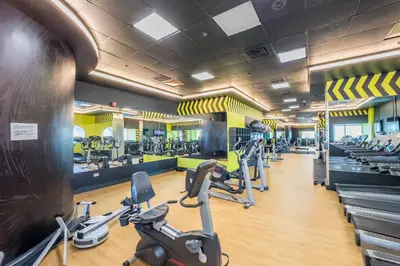 a gym with treadmills and cardio equipment in a building at Remodeled 1BR with Sky-High Picturesque Marina Views, Elite Residence, Dubai Marina by Deluxe Holiday Homes in Dubai