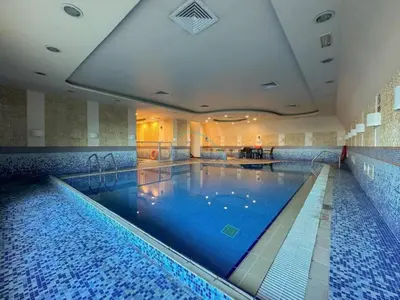 a large swimming pool in a hotel room at Remodeled 1BR with Sky-High Picturesque Marina Views, Elite Residence, Dubai Marina by Deluxe Holiday Homes in Dubai