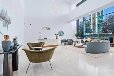 a lobby with couches and chairs in a building at FIRST CLASS 3BR Burj Khalifa & Fountain view in Dubai