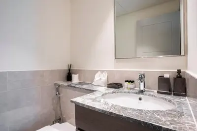 a bathroom with a sink and a mirror at FIRST CLASS 3BR Burj Khalifa & Fountain view in Dubai