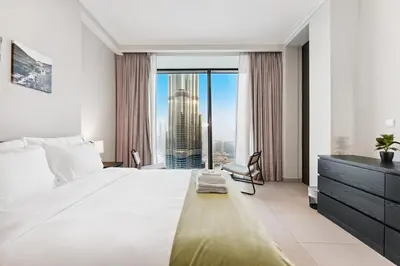 a bedroom with a large bed and a large window at 3BR Family abode with Iconic Burj Khalifa view in Dubai