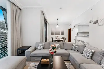 a living room with a couch and a table at 3BR Family abode with Iconic Burj Khalifa view in Dubai