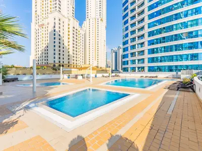 a pool in the middle of a city with tall buildings at The 'Mallorca' Condo - JBR Beachfront Stay in Dubai