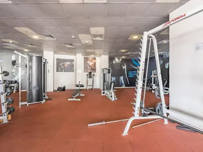 a gym with several treadmills and machines at The 'Mallorca' Condo - JBR Beachfront Stay in Dubai