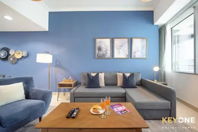 a living room with a couch and a table at Fascinating Ocean Views in a One Bedroom in Dubai