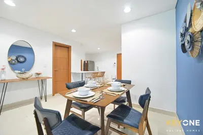 a dining room with a wooden table and chairs at Fascinating Ocean Views in a One Bedroom in Dubai