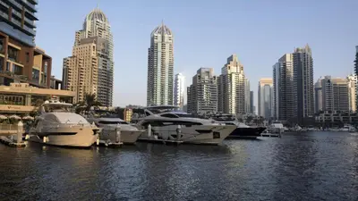 a group of boats docked in the water in a city at Marina Majesty- Homely & Cozy 2BR, CanalView, Central Location in Dubai