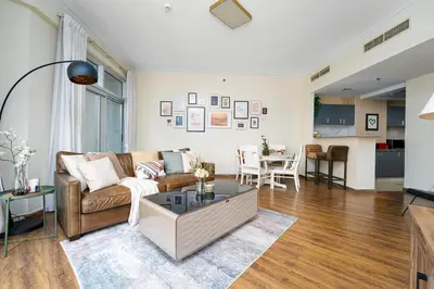a living room with a couch and a table at Marina Majesty- Homely & Cozy 2BR, CanalView, Central Location in Dubai